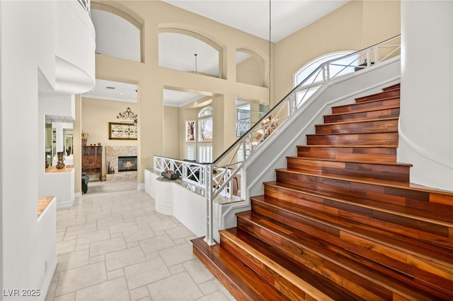 7520 Captains Harbor Dr, Las Vegas, NV 89117 - stairs with a high ceiling and a tile fireplace