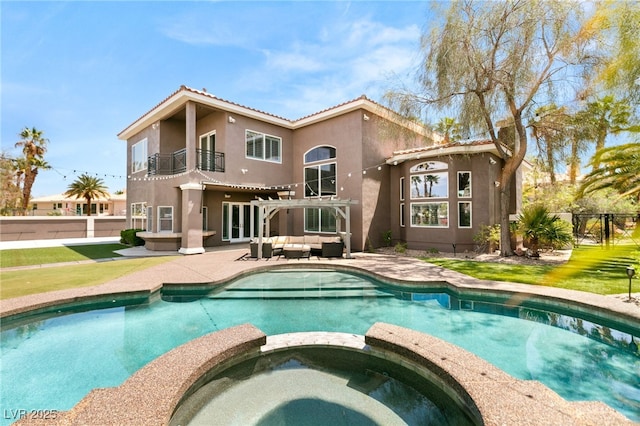 7520 Captains Harbor Dr, Las Vegas, NV 89117 - back of property with a balcony, an outdoor living space, stucco siding, a pool with connected hot tub, and a tiled roof