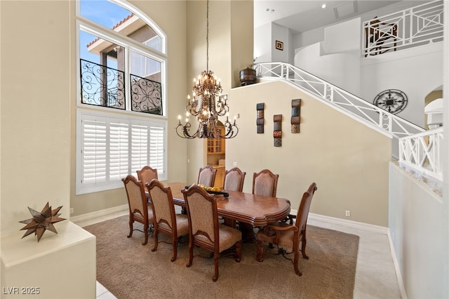 7520 Captains Harbor Dr, Las Vegas, NV 89117 - dining area featuring a towering ceiling, healthy amount of natural light, a chandelier, and light colored carpet