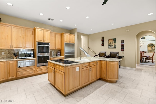 7520 Captains Harbor Dr, Las Vegas, NV 89117 - kitchen featuring a warming drawer, appliances with stainless steel finishes, arched walkways, decorative backsplash, and recessed lighting