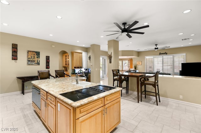7520 Captains Harbor Dr, Las Vegas, NV 89117 - kitchen with black electric stovetop, ceiling fan, recessed lighting, an island with sink, and open floor plan