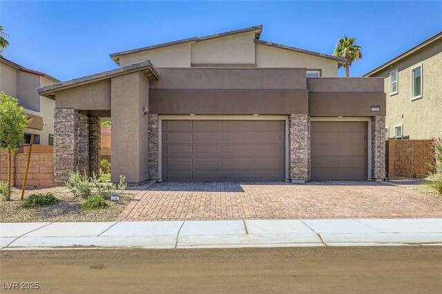 1289 Valencia Cliffs Ave, Henderson, NV 89012 - view of front facade featuring stucco siding, decorative driveway, stone siding, and an attached garage