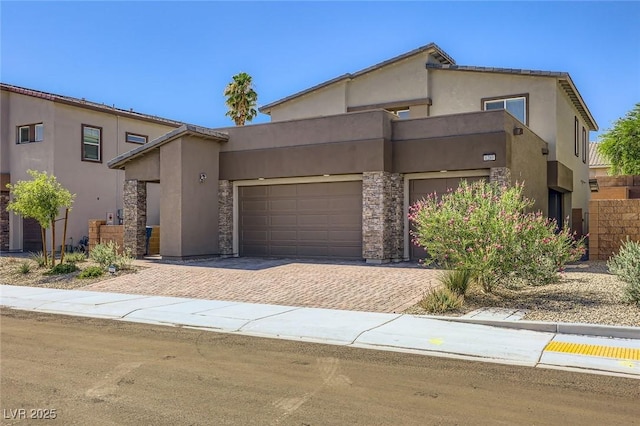 1289 Valencia Cliffs Ave, Henderson, NV 89012 - view of front of property with decorative driveway, stucco siding, a garage, and stone siding