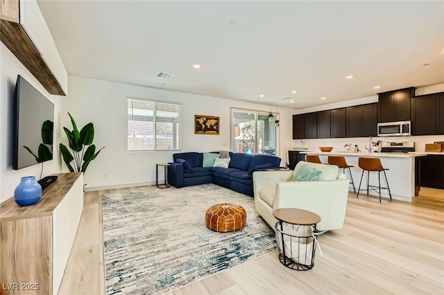 1289 Valencia Cliffs Ave, Henderson, NV 89012 - living area with light wood-type flooring and recessed lighting