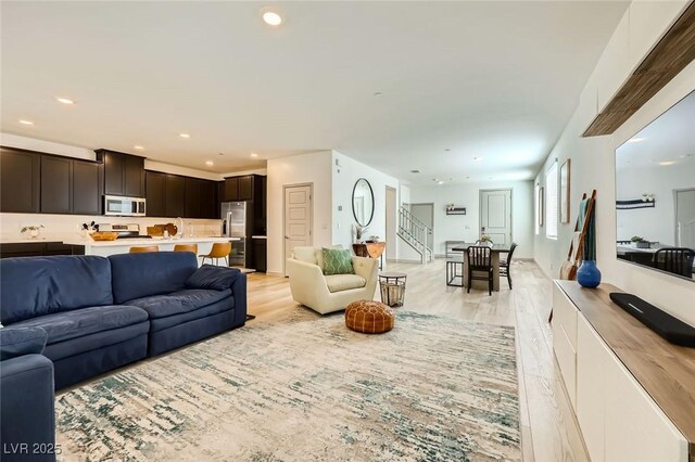 1289 Valencia Cliffs Ave, Henderson, NV 89012 - living room featuring light wood-type flooring, recessed lighting, and stairs