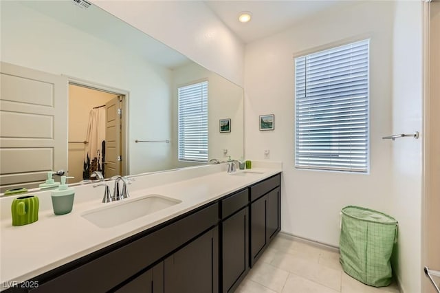 1289 Valencia Cliffs Ave, Henderson, NV 89012 - full bath with double vanity, tile patterned flooring, healthy amount of natural light, and recessed lighting