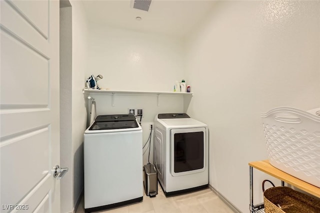1289 Valencia Cliffs Ave, Henderson, NV 89012 - laundry room with washing machine and clothes dryer and light tile patterned floors
