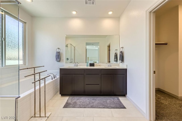 1289 Valencia Cliffs Ave, Henderson, NV 89012 - full bathroom with double vanity, a garden tub, recessed lighting, tile patterned flooring, and a shower with shower door