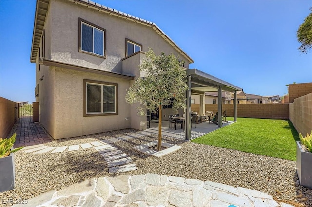 1289 Valencia Cliffs Ave, Henderson, NV 89012 - rear view of house with a fenced backyard, stucco siding, a patio, and a gate