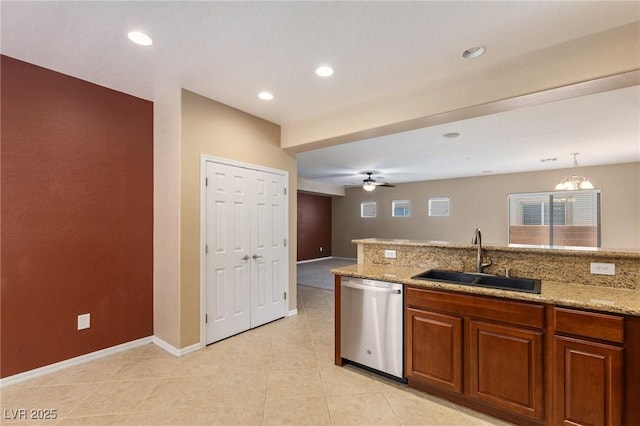 4117 Gliding Gulls Ave, North Las Vegas, NV 89084 - kitchen featuring stainless steel dishwasher, brown cabinets, ceiling fan, light stone counters, and light tile patterned floors
