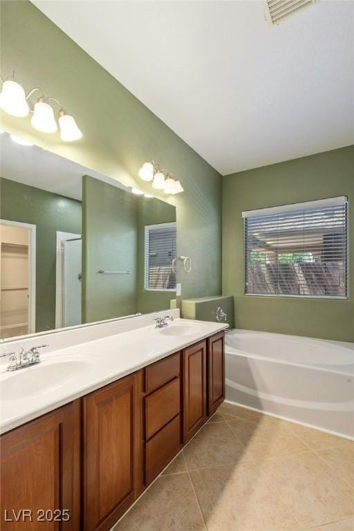 4117 Gliding Gulls Ave, North Las Vegas, NV 89084 - bathroom featuring tile patterned flooring, double vanity, and a bath