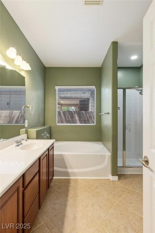 4117 Gliding Gulls Ave, North Las Vegas, NV 89084 - full bathroom featuring a bath, tile patterned flooring, vanity, and a shower stall