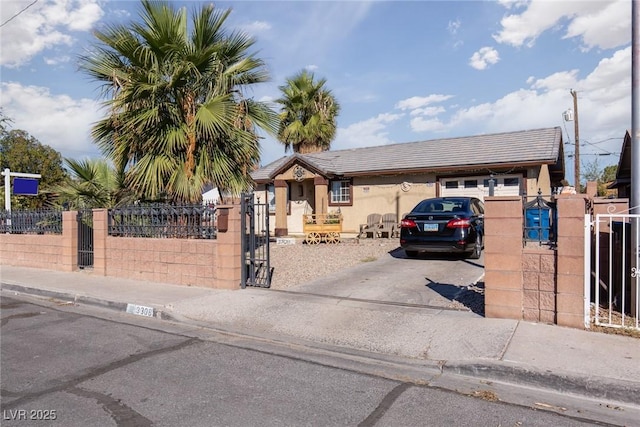 3308 Tabor Ave, North Las Vegas, NV 89030 - view of front facade with a gate, driveway, a fenced front yard, and stucco siding