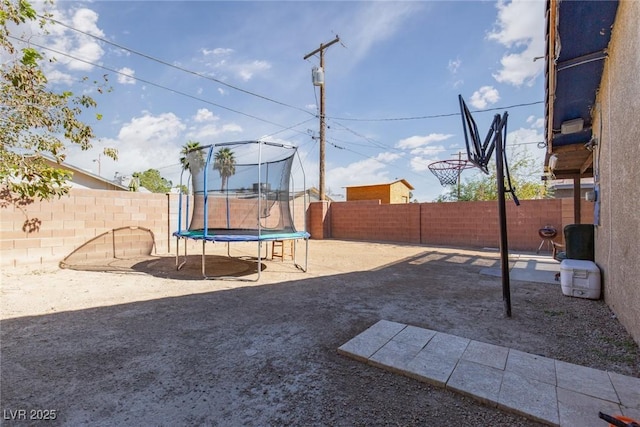 3308 Tabor Ave, North Las Vegas, NV 89030 - fenced backyard featuring a trampoline