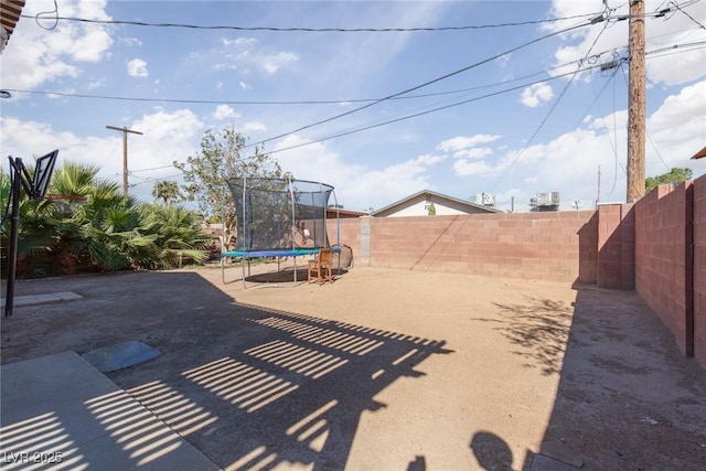 3308 Tabor Ave, North Las Vegas, NV 89030 - fenced backyard with a trampoline