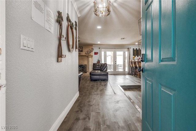 5403 Tamarus St, Las Vegas, NV 89119 - foyer with a textured wall, dark wood-type flooring, french doors, a chandelier, and ornamental molding