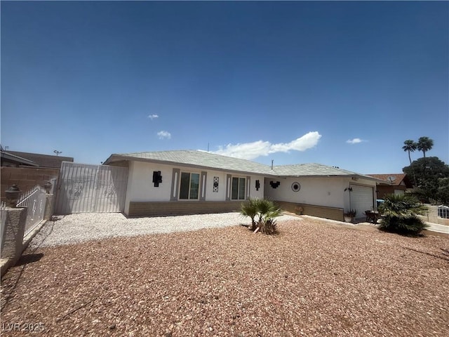 5403 Tamarus St, Las Vegas, NV 89119 - back of property with a garage and stucco siding