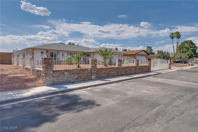 5403 Tamarus St, Las Vegas, NV 89119 - ranch-style house featuring a fenced front yard, a gate, and stone siding