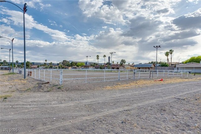 5403 Tamarus St, Las Vegas, NV 89119 - view of dirt / gravel road featuring street lights
