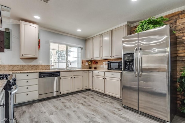 5403 Tamarus St, Las Vegas, NV 89119 - kitchen with appliances with stainless steel finishes, ornamental molding, light wood-style flooring, tasteful backsplash, and recessed lighting
