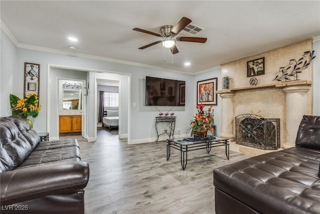 5403 Tamarus St, Las Vegas, NV 89119 - living area featuring crown molding, a ceiling fan, light wood-style floors, a high end fireplace, and recessed lighting