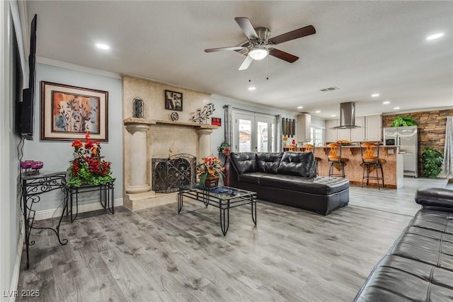 5403 Tamarus St, Las Vegas, NV 89119 - living room with ornamental molding, ceiling fan, light wood-style floors, a large fireplace, and recessed lighting