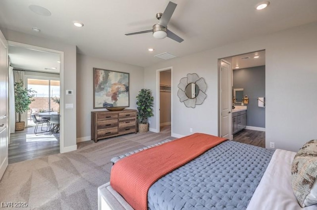 1408 Eva Creek Dr Unit 27, North Las Vegas, NV 89084 - bedroom featuring recessed lighting, a walk in closet, connected bathroom, carpet, and a ceiling fan