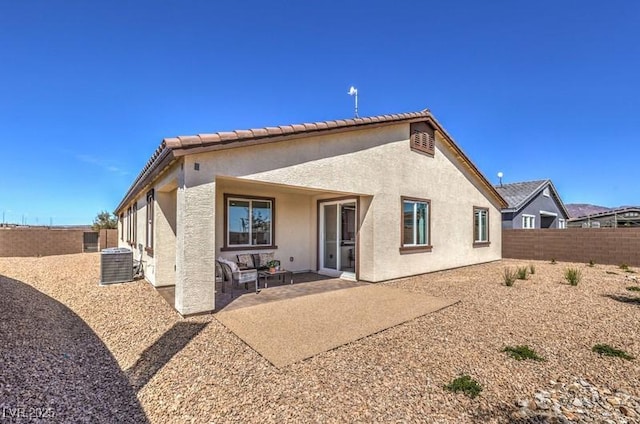 1408 Eva Creek Dr Unit 27, North Las Vegas, NV 89084 - rear view of property featuring stucco siding, a fenced backyard, and a patio area