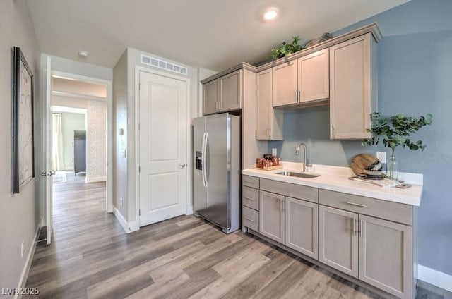 1408 Eva Creek Dr Unit 27, North Las Vegas, NV 89084 - kitchen with stainless steel fridge, light wood-type flooring, and gray cabinets