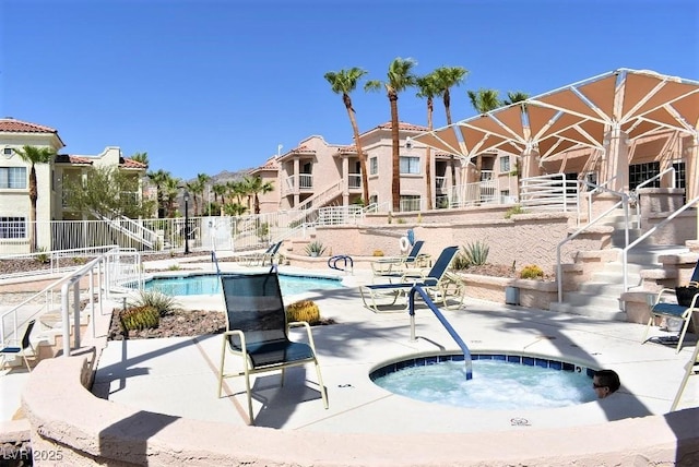 1940 Las Palmas Ln Unit 272, Laughlin, NV 89029 - community pool with stairway, a community hot tub, a patio area, and a residential view