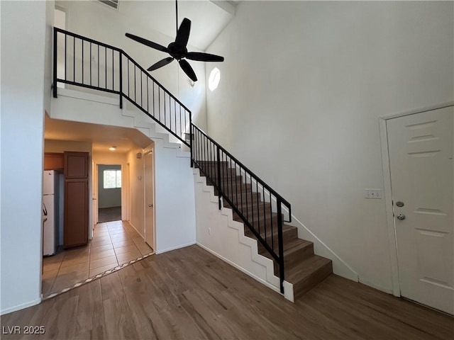 5253 Westwind Rd, Las Vegas, NV 89118 - stairs with high vaulted ceiling, ceiling fan, and wood finished floors