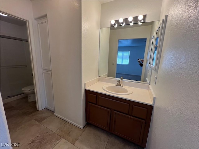 5253 Westwind Rd, Las Vegas, NV 89118 - bathroom featuring vanity, tile patterned flooring, a shower stall, and a textured wall