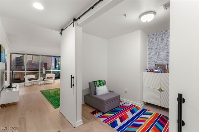 4525 Dean Martin Dr Unit 1007, Las Vegas, NV 89103 - living area featuring wood finished floors and a barn door