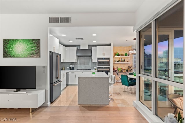 4525 Dean Martin Dr Unit 1007, Las Vegas, NV 89103 - kitchen featuring high quality fridge, white cabinetry, gas stovetop, light countertops, and modern cabinets