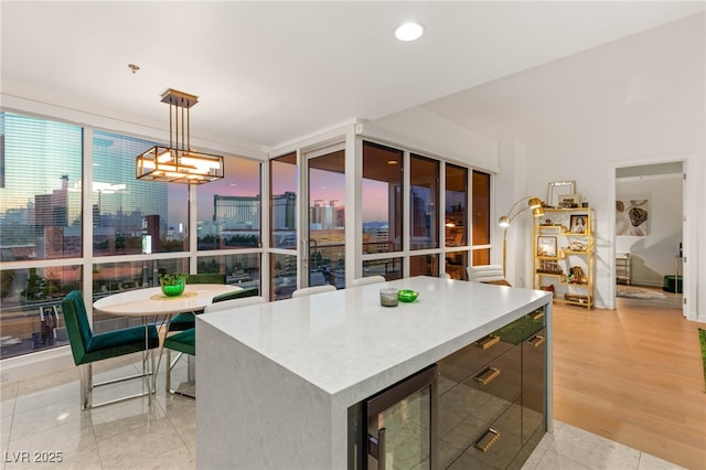 4525 Dean Martin Dr Unit 1007, Las Vegas, NV 89103 - kitchen with wine cooler, decorative light fixtures, light countertops, a kitchen island, and modern cabinets