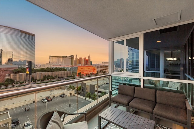 4525 Dean Martin Dr Unit 1007, Las Vegas, NV 89103 - balcony featuring a city view and an outdoor living space