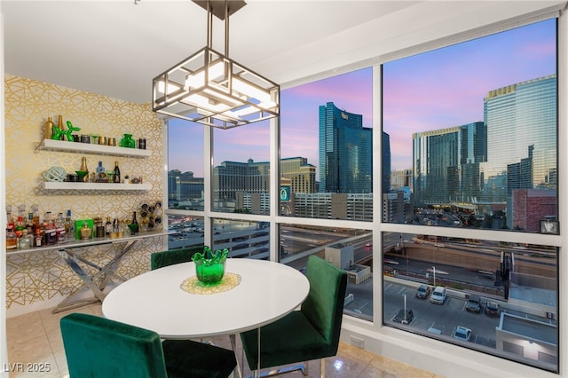 4525 Dean Martin Dr Unit 1007, Las Vegas, NV 89103 - tiled dining room with wallpapered walls, a skyline view, and a chandelier