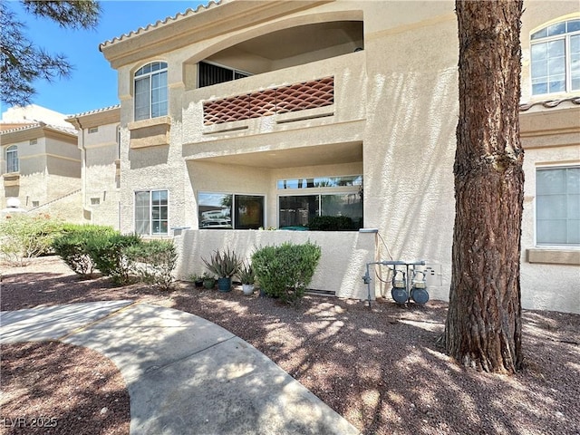 7400 W Flamingo Rd Unit 1094, Las Vegas, NV 89147 - back of property featuring stucco siding and a balcony