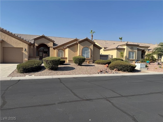 6679 Alpine Brooks Ave, Las Vegas, NV 89130 - mediterranean / spanish home with stucco siding, driveway, an attached garage, and a tile roof