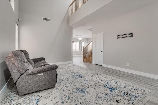 8021 Dancing Springs St, Las Vegas, NV 89143 - sitting room featuring wood finished floors, stairs, and a towering ceiling