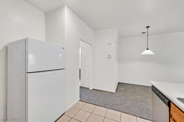 5960 Palmilla St Unit 7, North Las Vegas, NV 89031 - kitchen featuring freestanding refrigerator, dishwasher, light colored carpet, light countertops, and decorative light fixtures