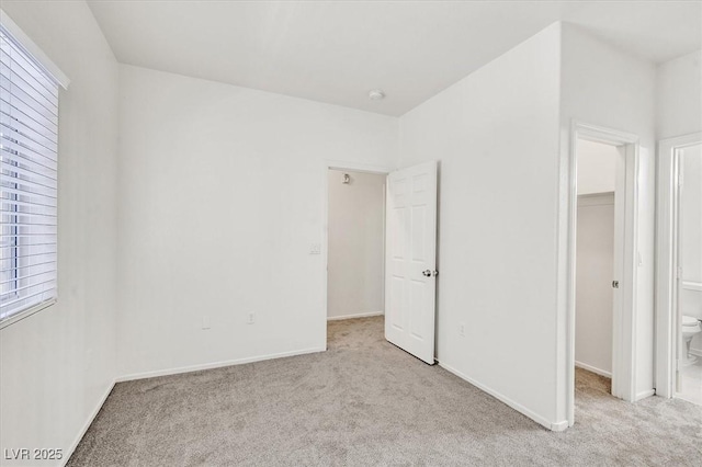 5960 Palmilla St Unit 7, North Las Vegas, NV 89031 - unfurnished bedroom with carpet, a spacious closet, and multiple windows