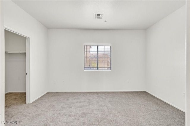 5960 Palmilla St Unit 7, North Las Vegas, NV 89031 - unfurnished bedroom featuring carpet floors, a walk in closet, and a closet
