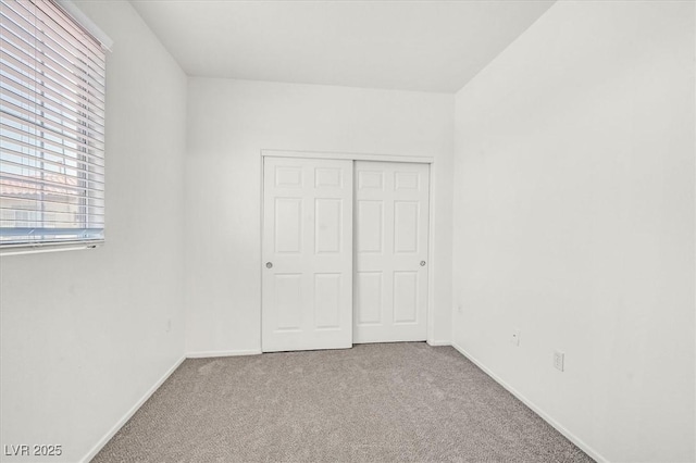 5960 Palmilla St Unit 7, North Las Vegas, NV 89031 - unfurnished bedroom featuring carpet floors and a closet