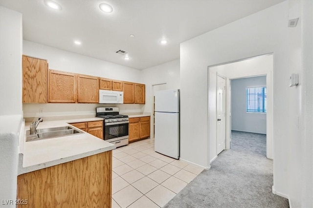 5960 Palmilla St Unit 7, North Las Vegas, NV 89031 - kitchen with white appliances, light countertops, light colored carpet, light tile patterned floors, and recessed lighting