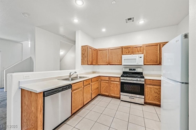 5960 Palmilla St Unit 7, North Las Vegas, NV 89031 - kitchen featuring stainless steel appliances, light countertops, light tile patterned flooring, recessed lighting, and a peninsula