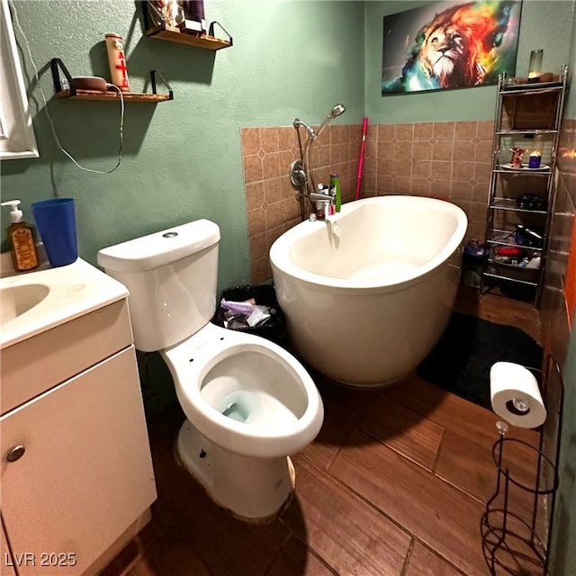 2709 Carroll St, North Las Vegas, NV 89030 - bathroom with a soaking tub, tile walls, vanity, a textured wall, and wood finished floors