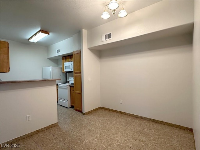 45 Maleena Mesa St Unit 211, Henderson, NV 89074 - kitchen with white appliances and brown cabinetry