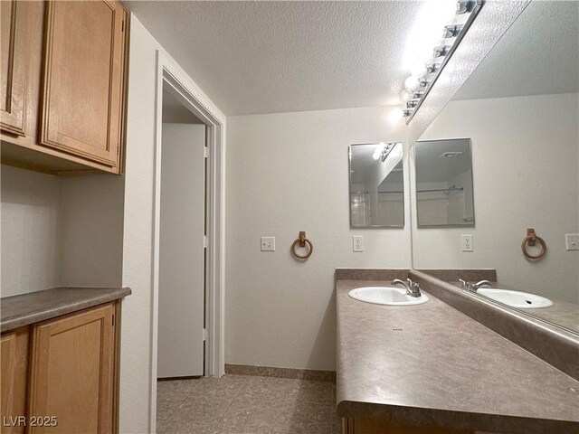 45 Maleena Mesa St Unit 211, Henderson, NV 89074 - bathroom with vanity and a textured ceiling