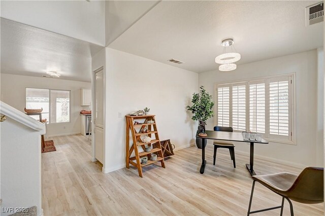 10921 Calcedonian St, Las Vegas, NV 89141 - office area featuring light wood-style flooring and a chandelier